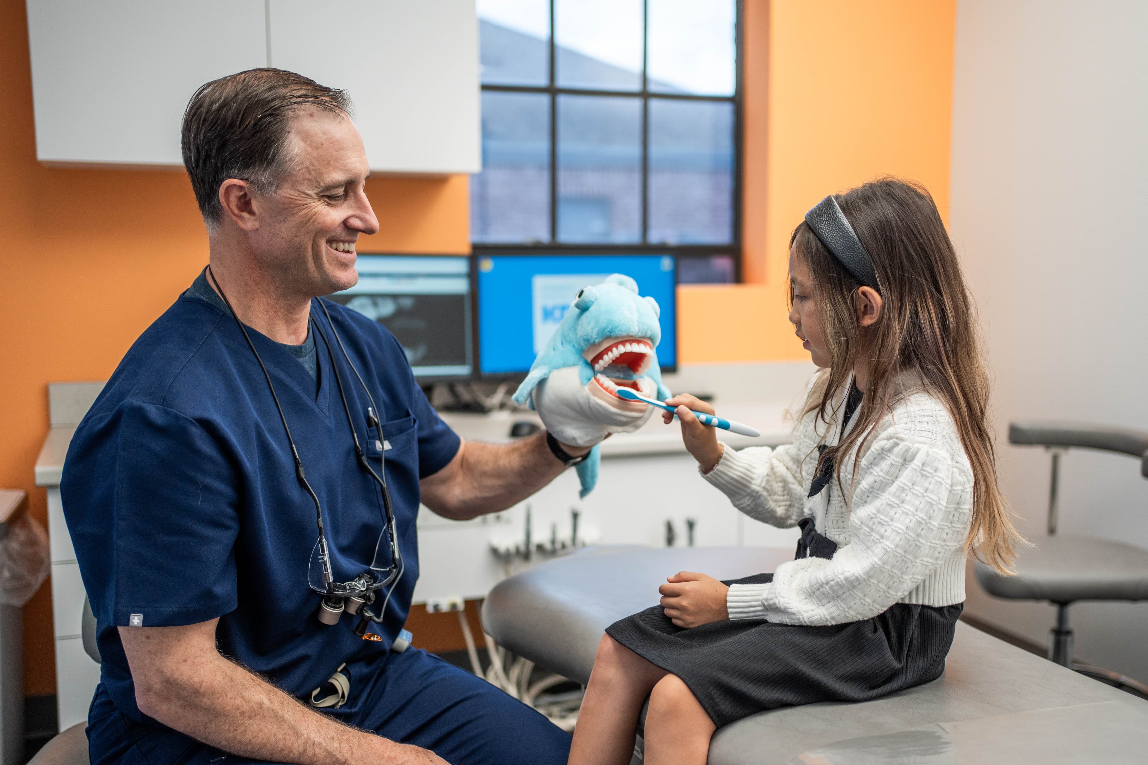 A KDC dentist with a young patient