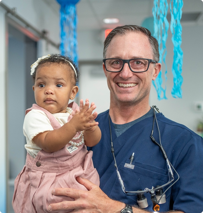 Kennedy Dental Care team member with a child patient