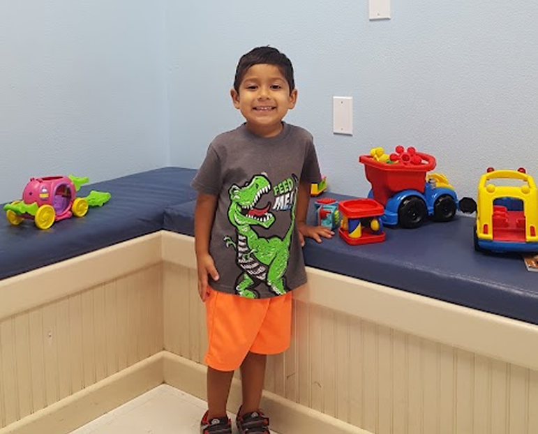 Team member with a young patient at the Calallen office