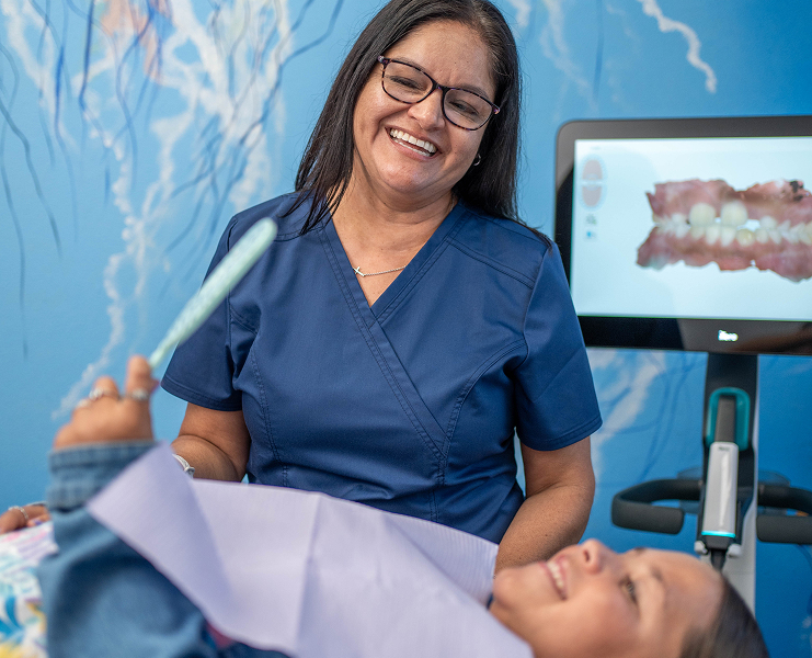 Child getting a gentle dental cleaning