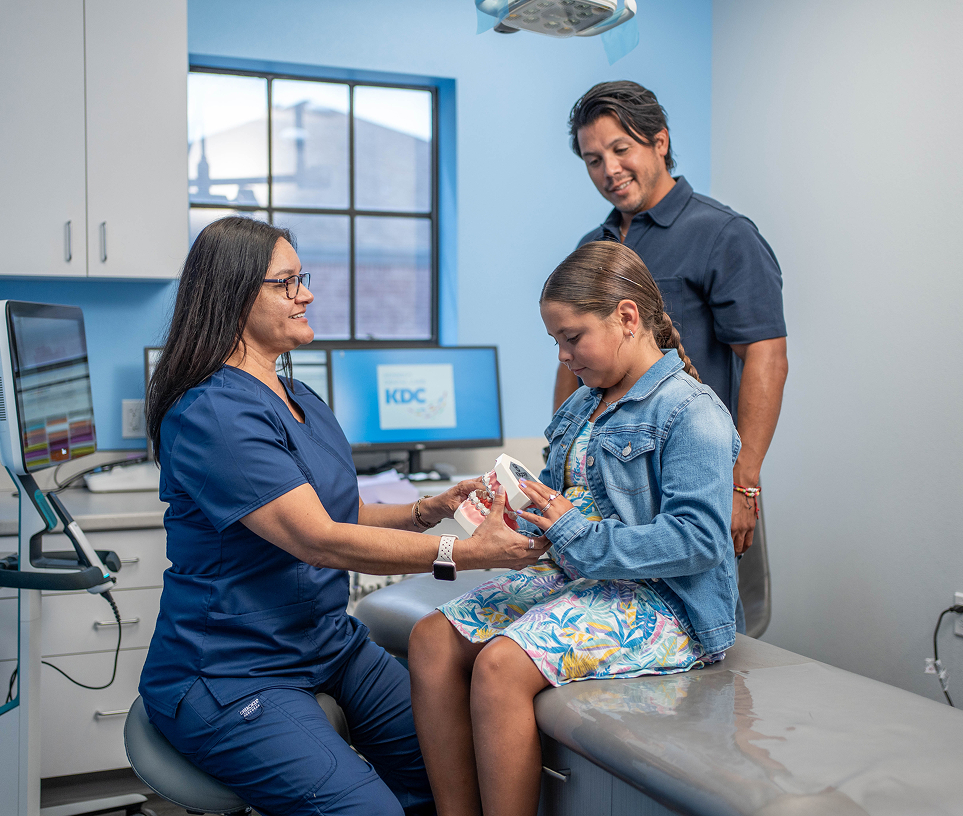 Hygienist polishing a young patient's teeth