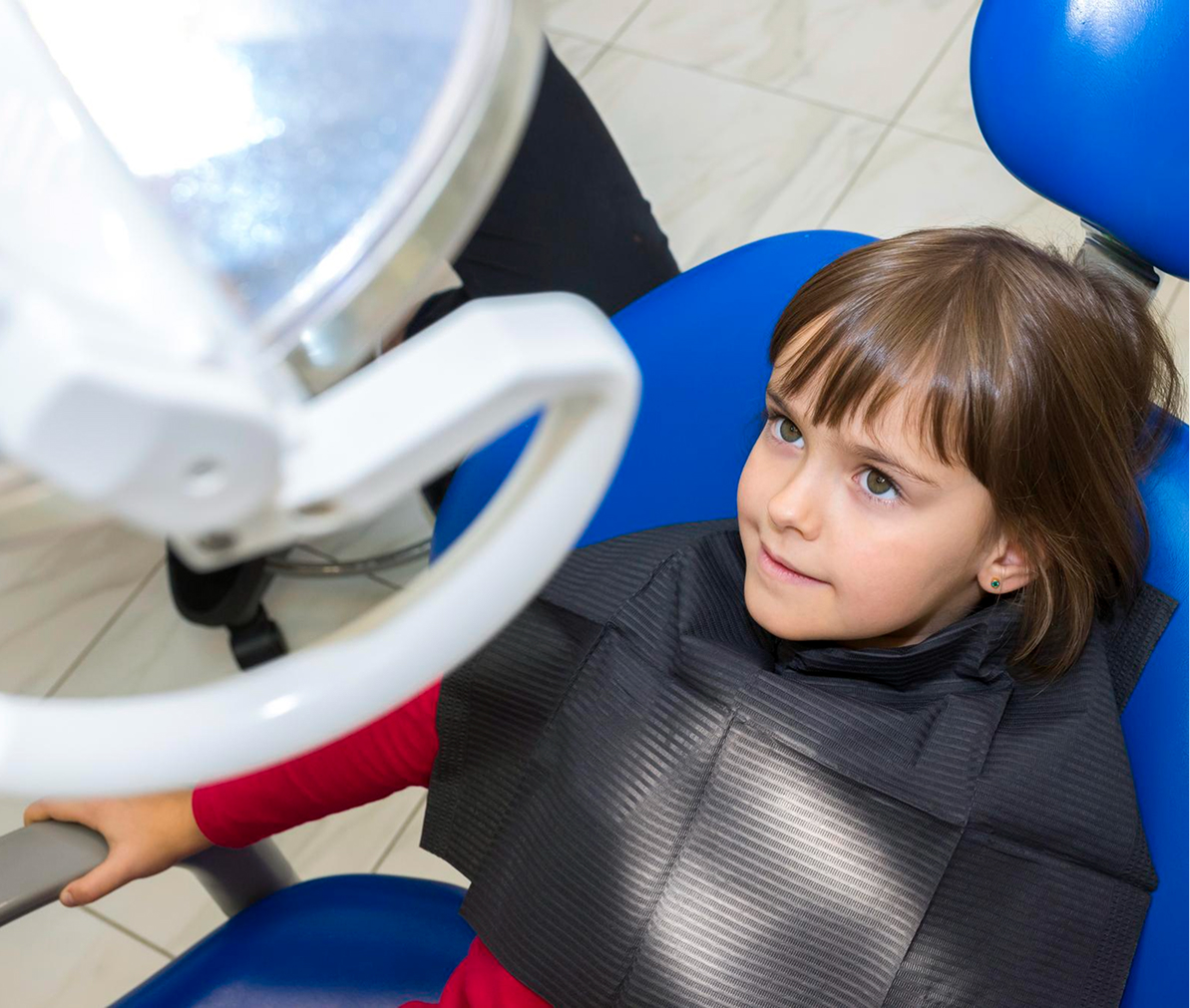 Dentist gently examining a young patient