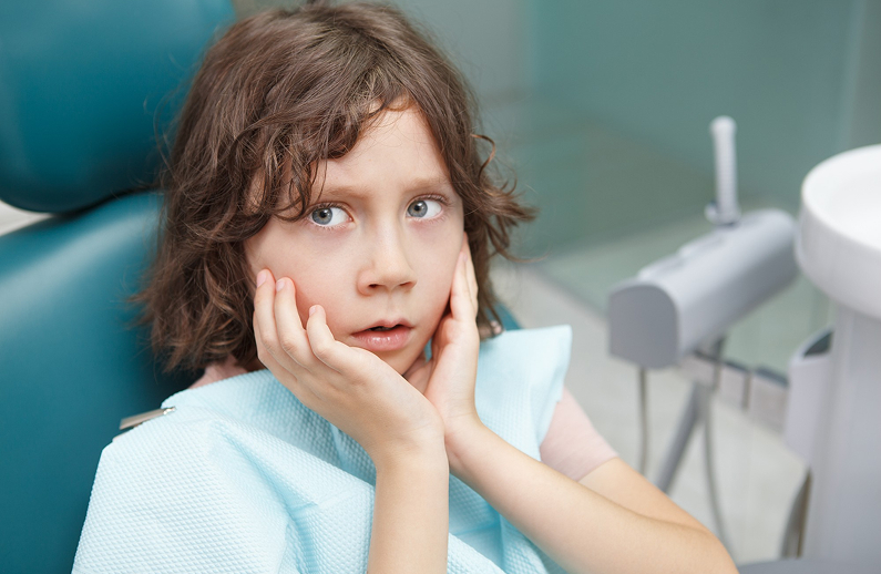 Relaxed young patient with a parent at Kennedy Dental Care