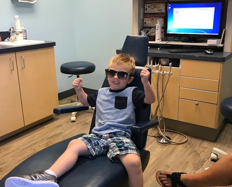 Team member with a young patient at the Saratoga office