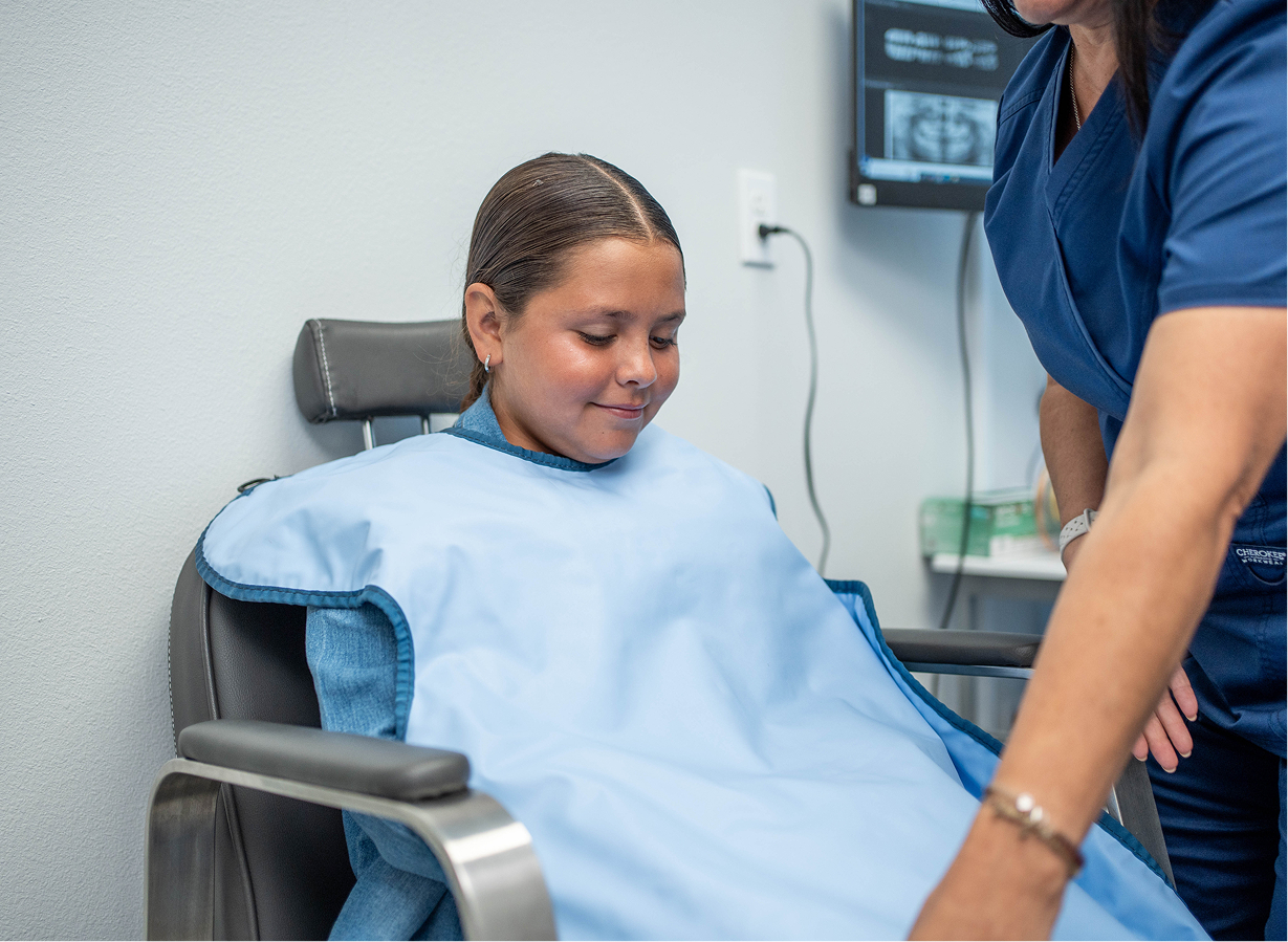 Parent cradling a newborn at Kennedy Dental Care
