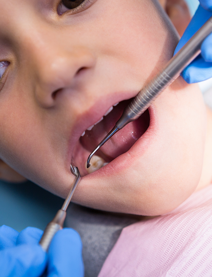 A young patient being examined at Kennedy Dental Care