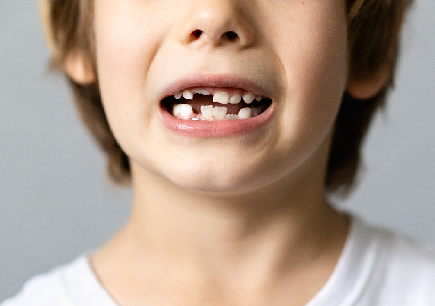 Dentist examining a child's smile after an injury